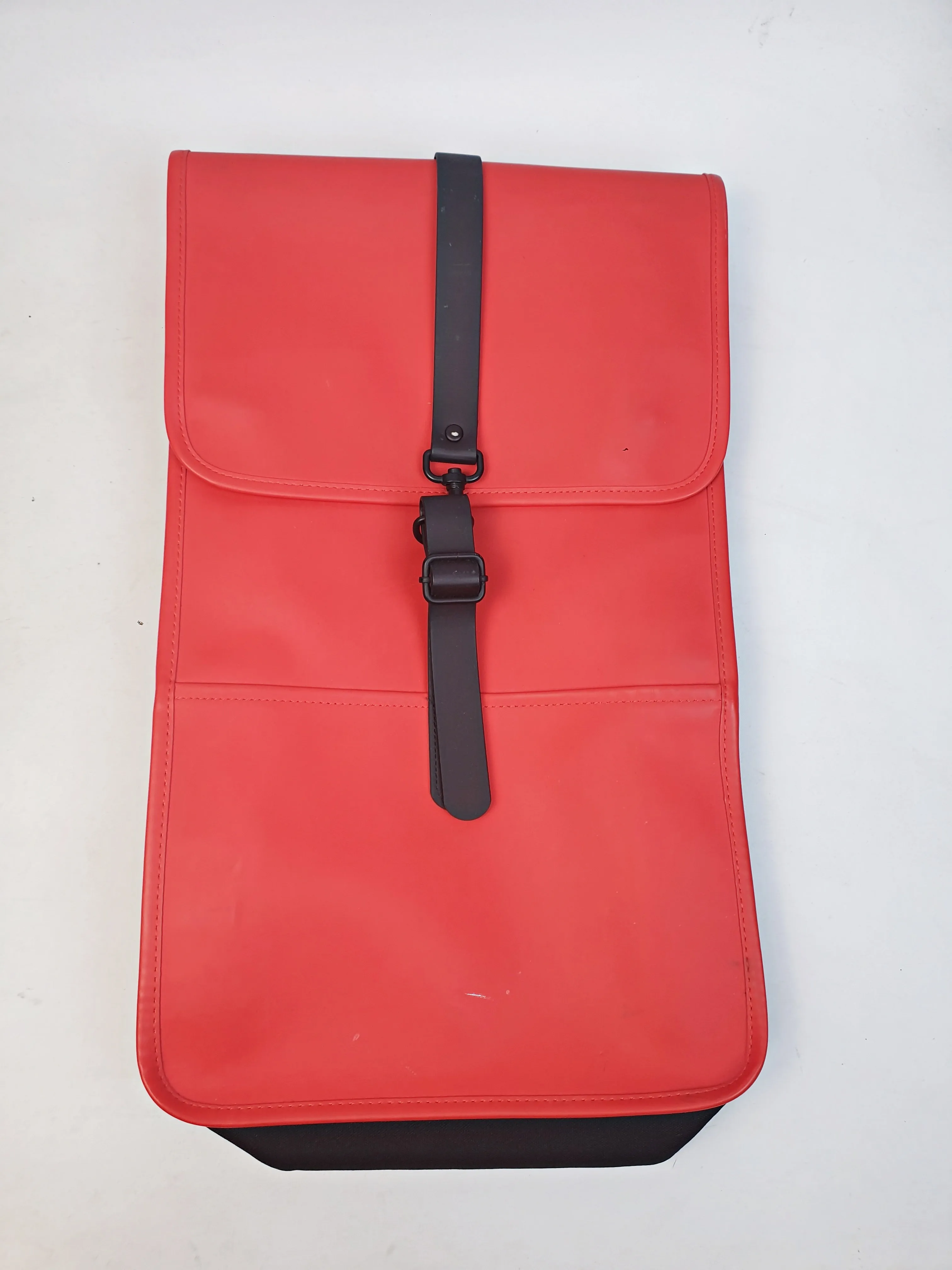 Rains large red rucksack / backpack with black straps and detail