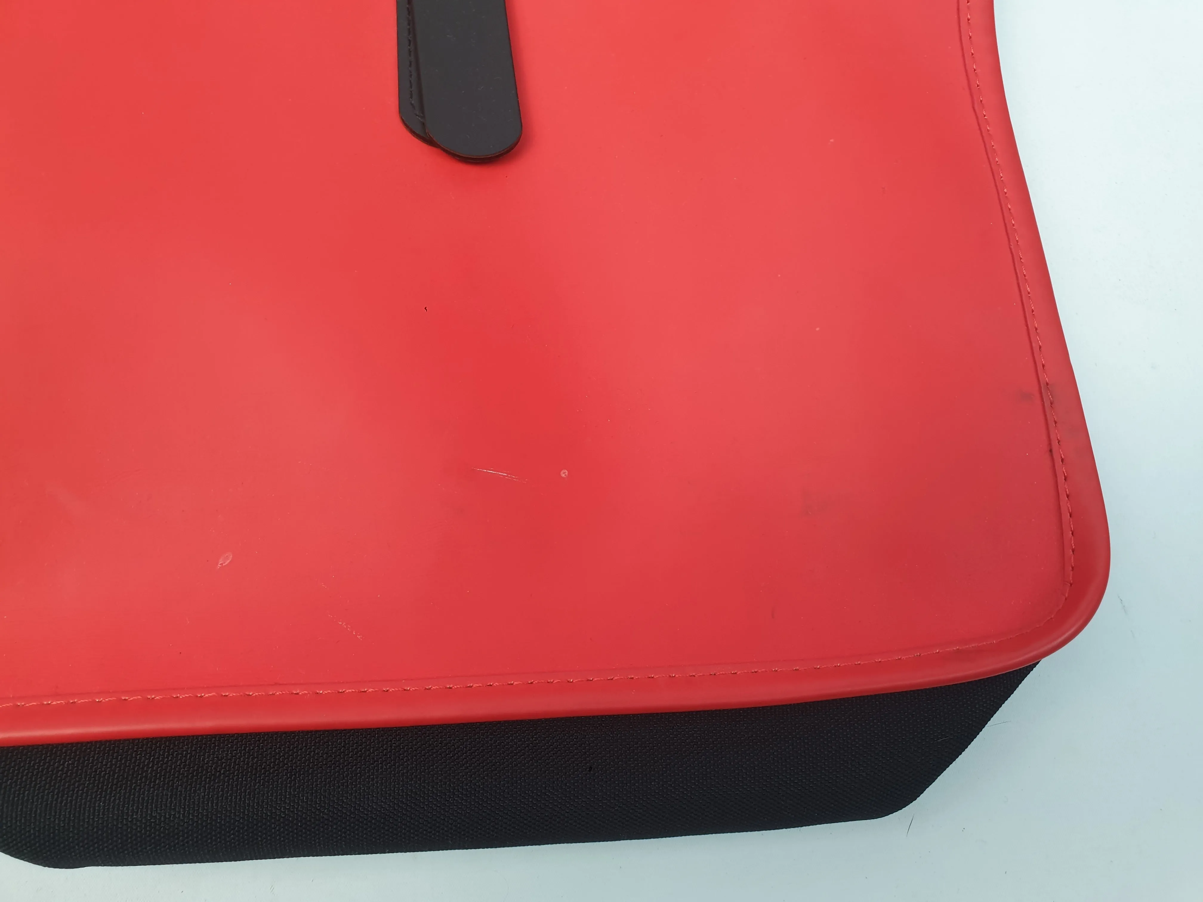 Rains large red rucksack / backpack with black straps and detail