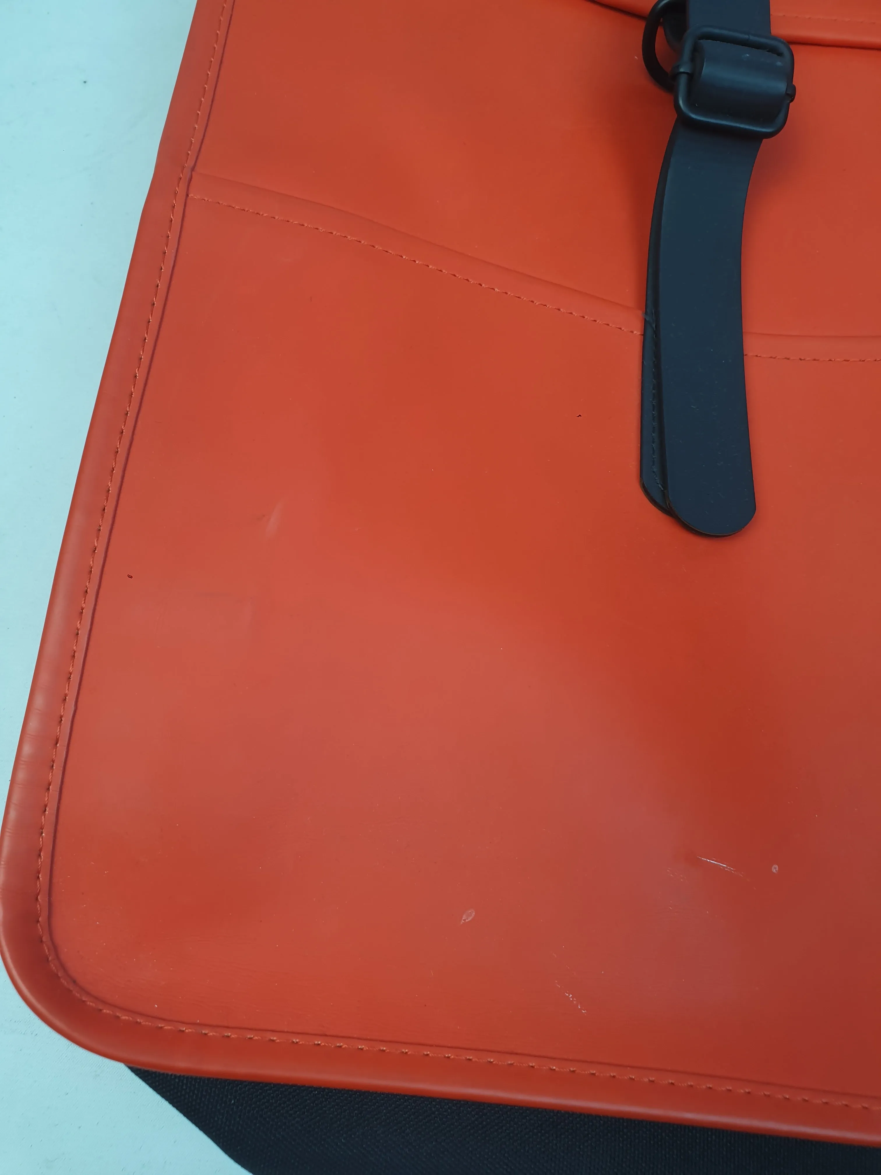 Rains large red rucksack / backpack with black straps and detail