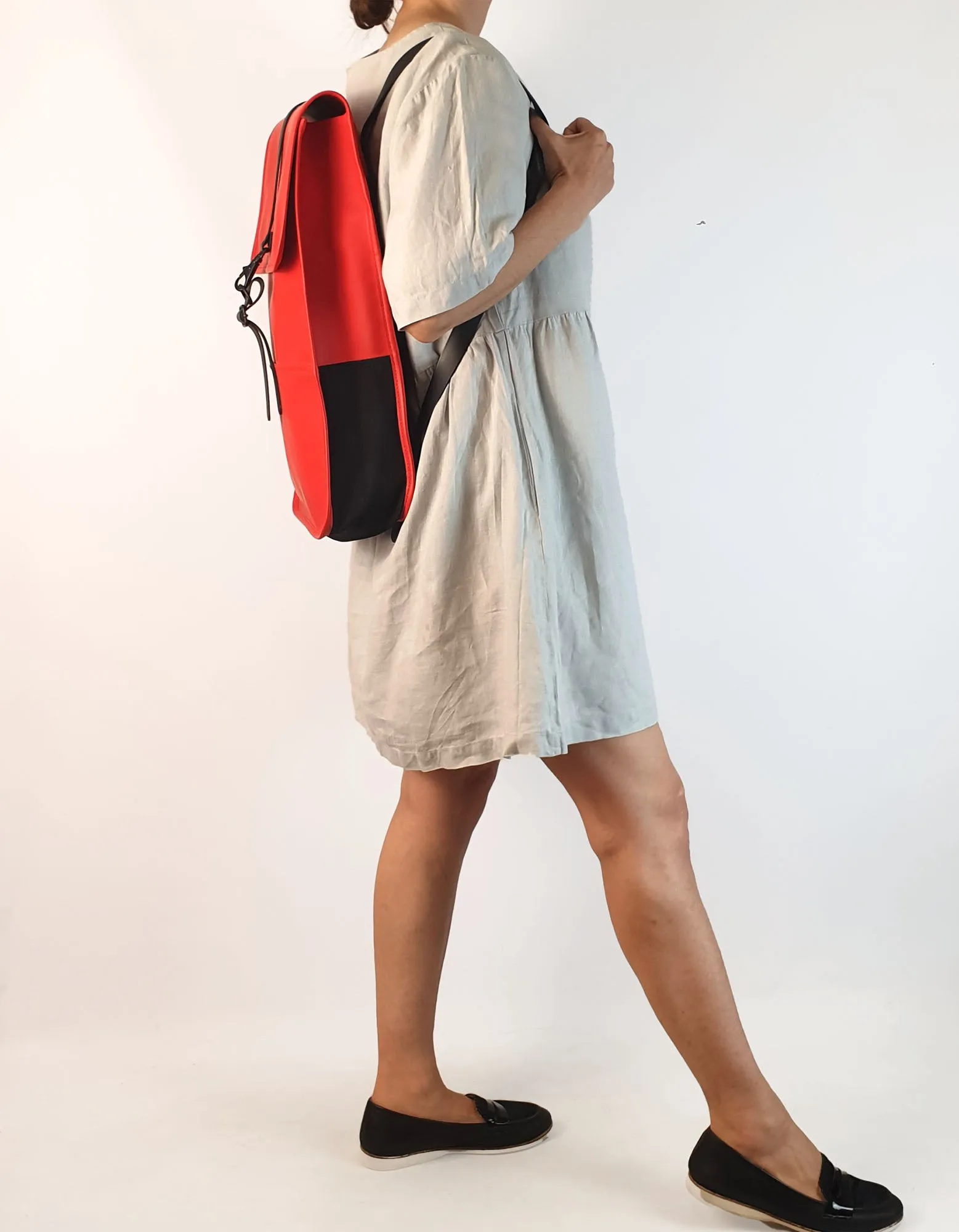 Rains large red rucksack / backpack with black straps and detail